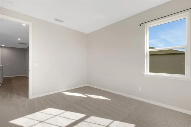a open kitchen with stainless steel appliances granite countertop a stove and a view of living room