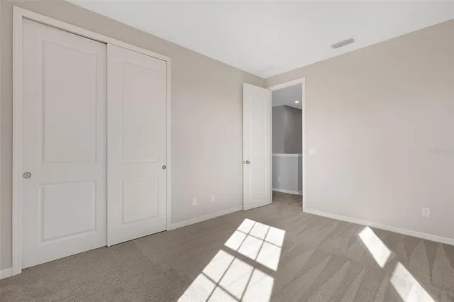 a view of a living room with a table and chairs