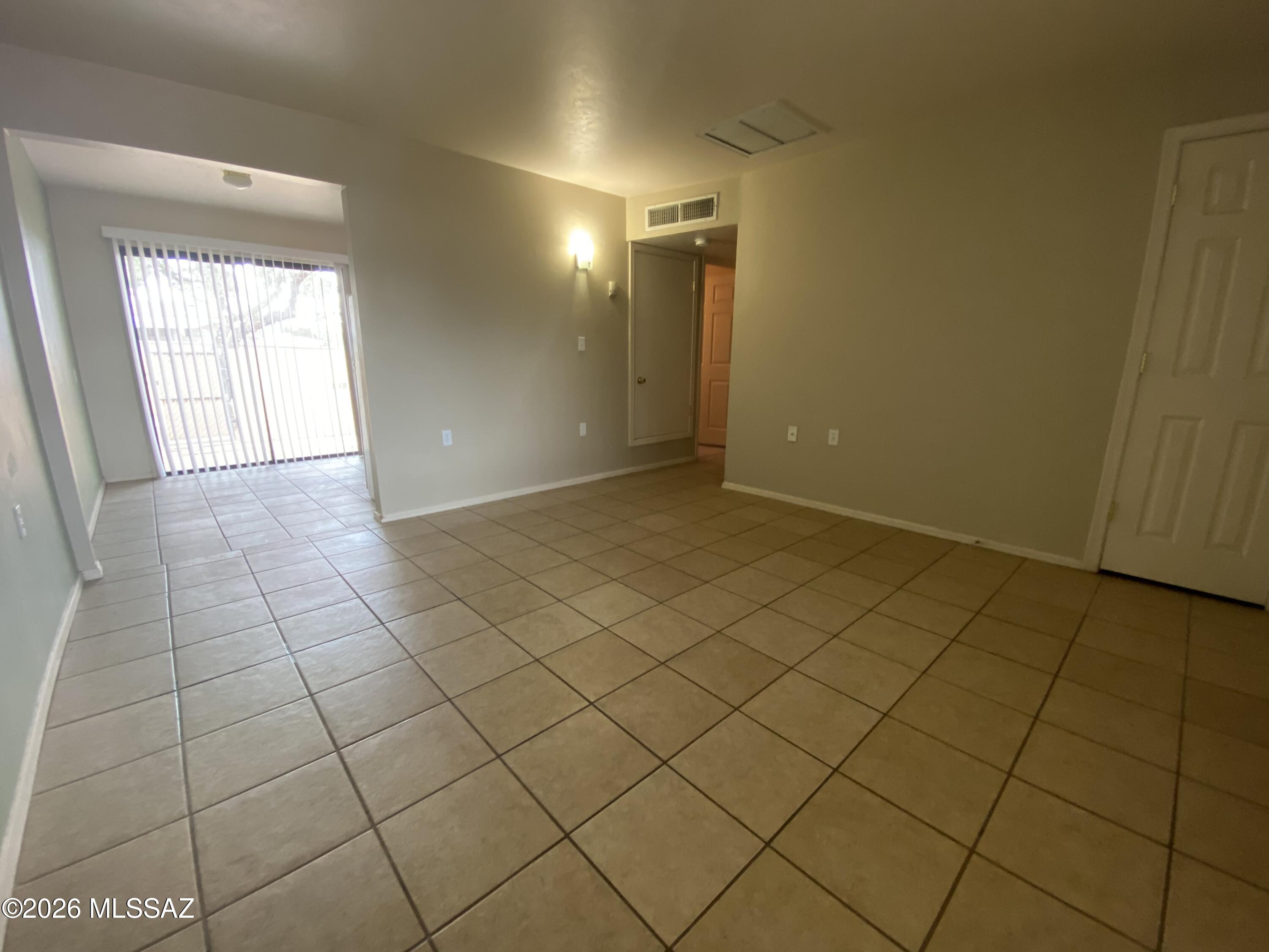 350 North Silverbell Road, Unit 94 Tucson, AZ 85745 - Photo 3 of 15 a view of an empty room and a window