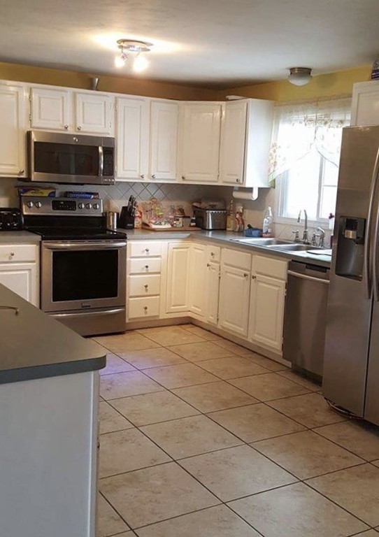 3 Rolling Ridge Road Rutland, MA 01543 - Photo 3 of 10 a kitchen with stainless steel appliances granite countertop a stove a sink and a microwave