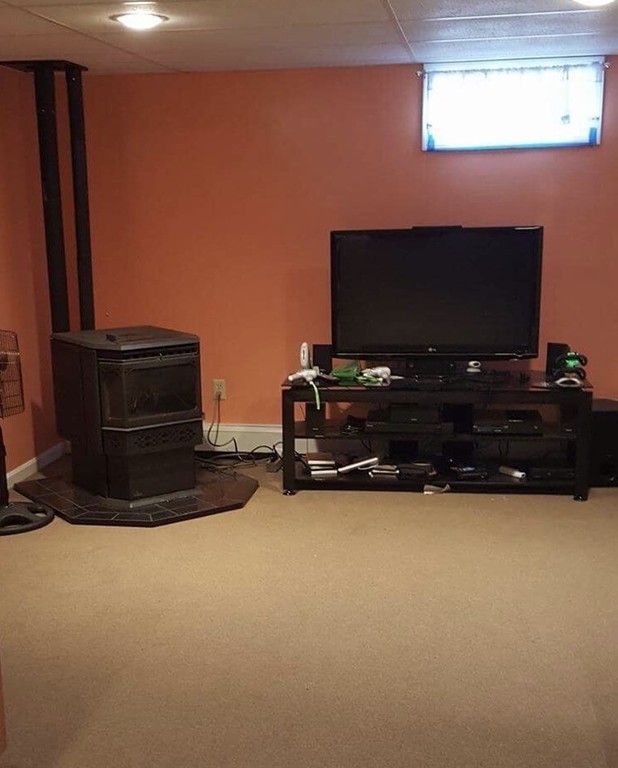 3 Rolling Ridge Road Rutland, MA 01543 - Photo 6 of 10 a living room with furniture a flat screen tv and a fireplace