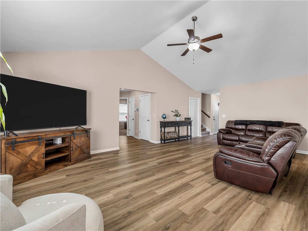 2520 Linmar Circle Anderson, SC 29621 - Photo 11 of 50 Discover a spacious living area featuring vaulted ceilings and resilient laminate flooring, perfect for relaxation and gatherings.