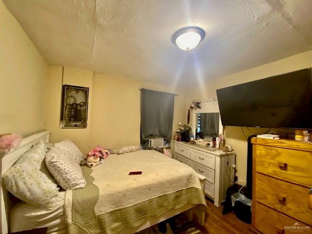 5910 Alpine Avenue Mission, TX 78574 - Photo 13 of 15 a bedroom with a bed and wooden floor