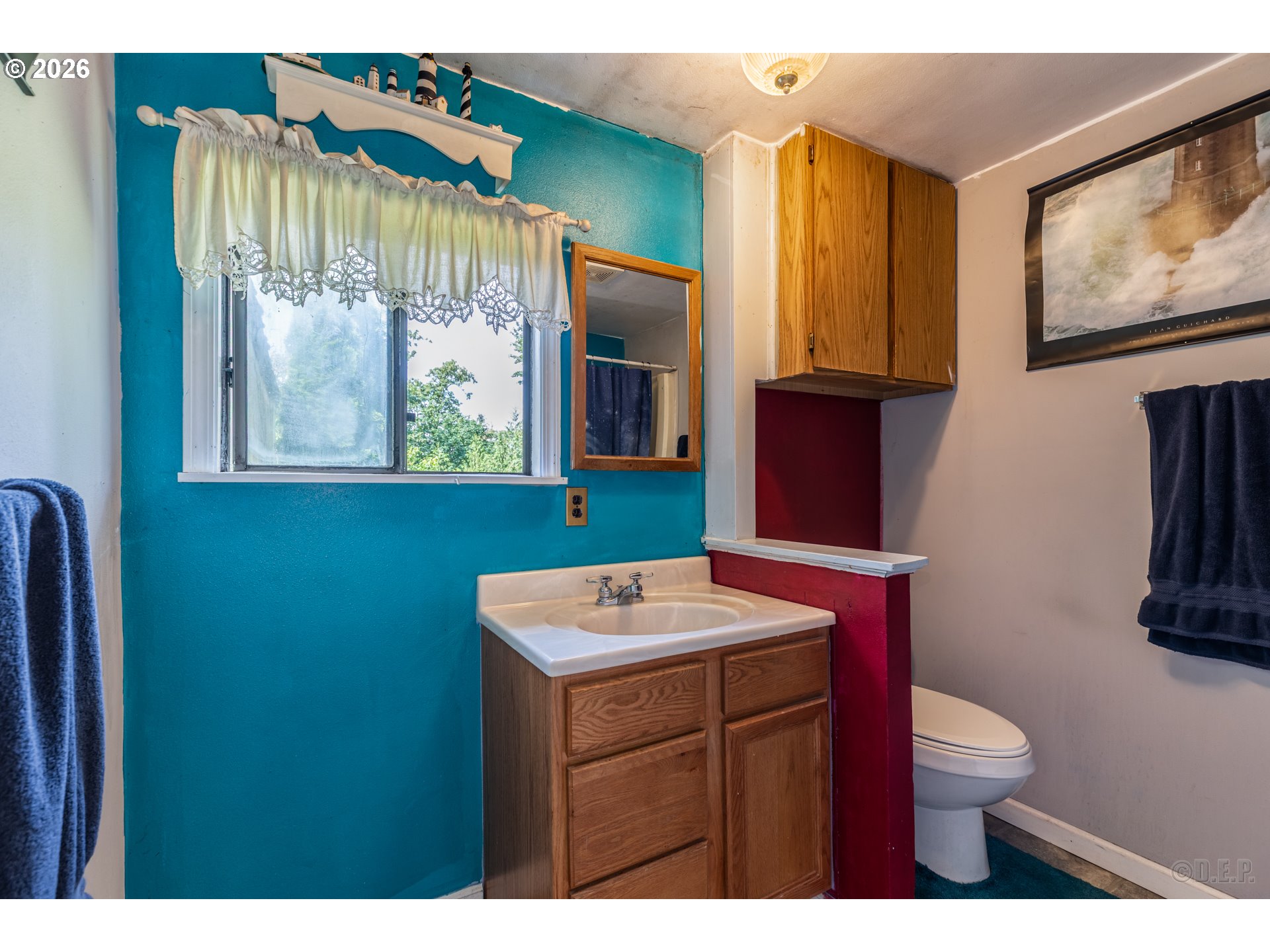66971 Maplecrest Road Deer Island, OR 97054 - Photo 15 of 24 a bathroom with a sink a mirror and a toilet