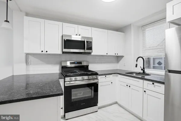 a kitchen with cabinets stainless steel appliances a sink and dishwasher