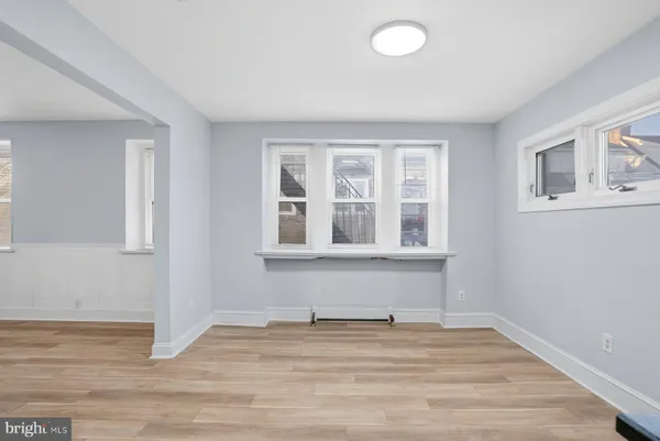 a view of a livingroom with wooden floor and a window