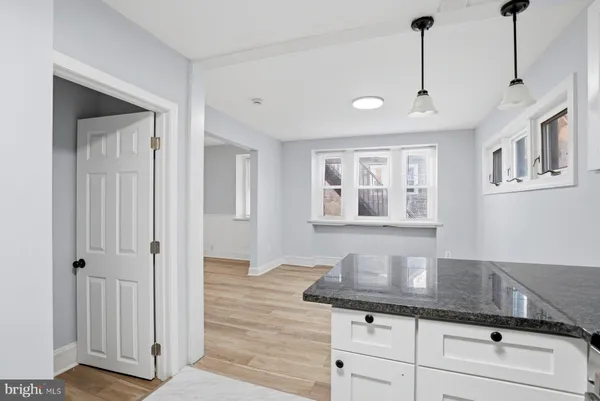 a view of a kitchen with granite countertop stainless steel appliances sink and cabinets