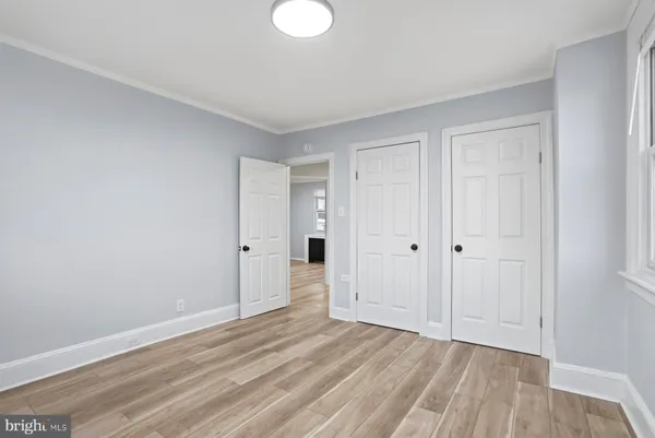 a view of an empty room and wooden floor