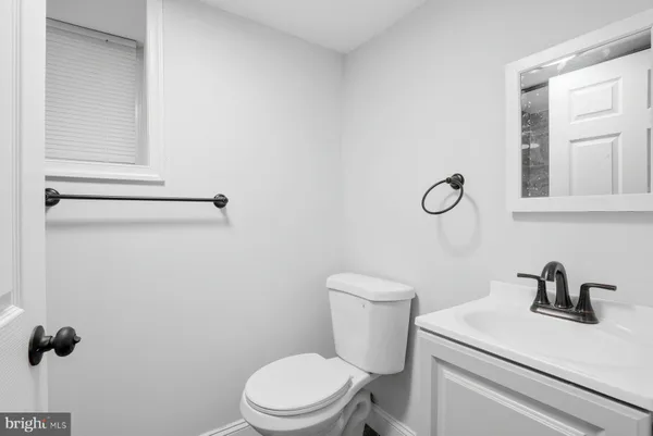 a white toilet sitting next to a bathroom sink
