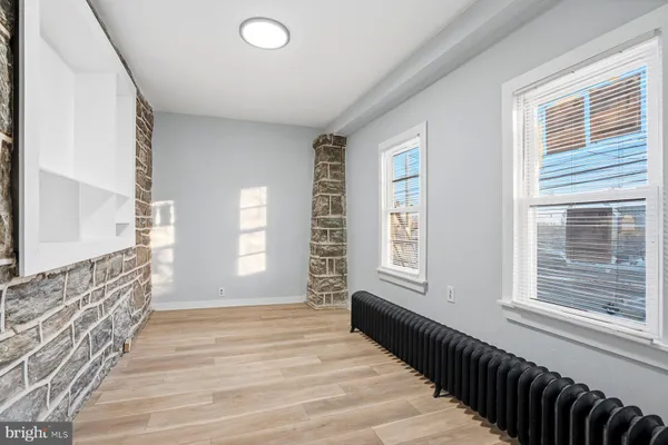 a view of an entryway with wooden floor and windows