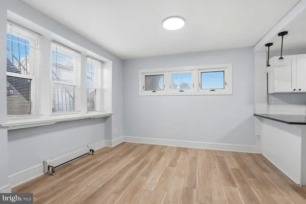 a room with a wooden floor and cabinets