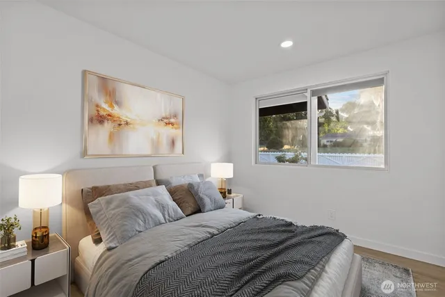 a bedroom with a bed and a painting on the wall