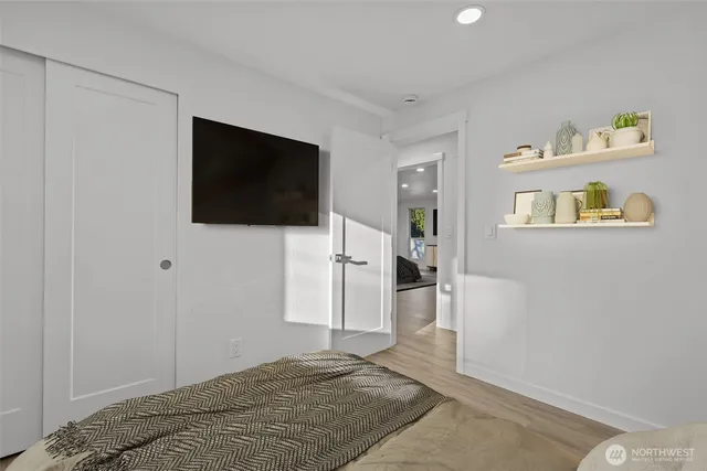 a bedroom with a bed and a flat screen tv