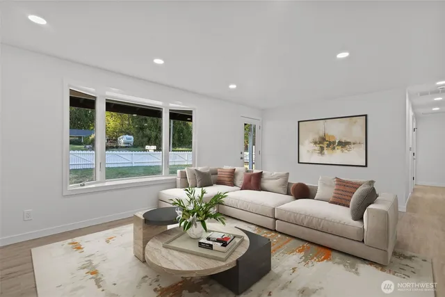 a living room with furniture potted plant and a window