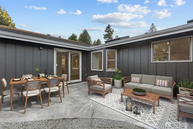 a backyard of a house with outdoor seating