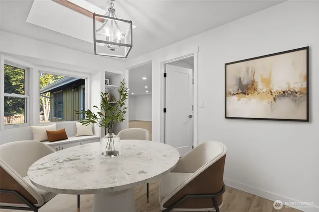 a view of a dining room with furniture and a chandelier