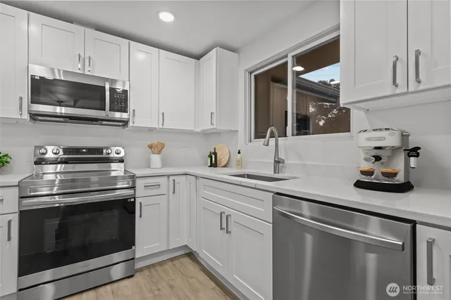 a kitchen with cabinets stainless steel appliances and wooden cabinets