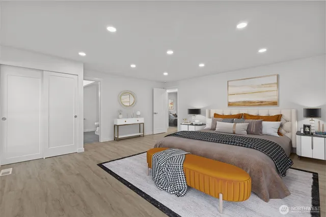 a spacious bedroom with a large bed and a couch