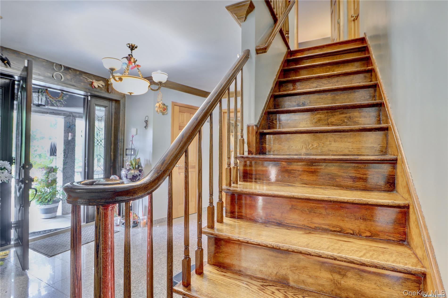 338 Cold Spring Road Syosset, NY 11791 - Photo 8 of 22 Stairs with a chandelier