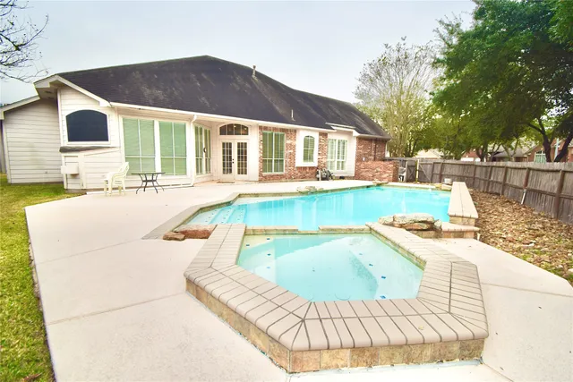 a view of a house with swimming pool and sitting area