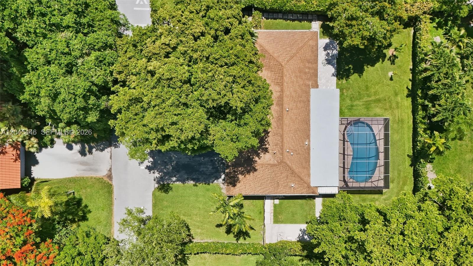 8440 Southwest 180th Street Palmetto Bay, FL 33157 - Photo 43 of 54 an aerial view of a house with a yard and garden