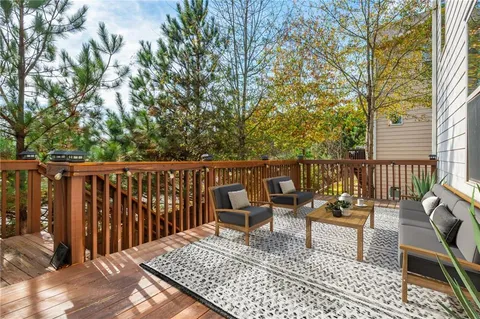 a balcony with wooden floor and furniture