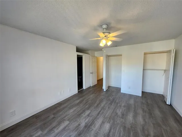 an empty room with wooden floor and door