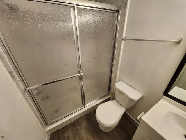 a bathroom with a toilet and a shower