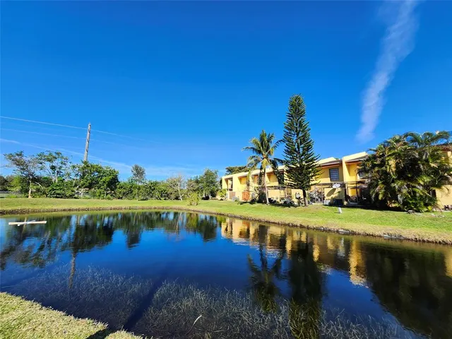 a view of a lake with a house in the background