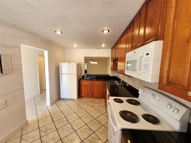 a kitchen with stainless steel appliances a refrigerator and a stove top oven