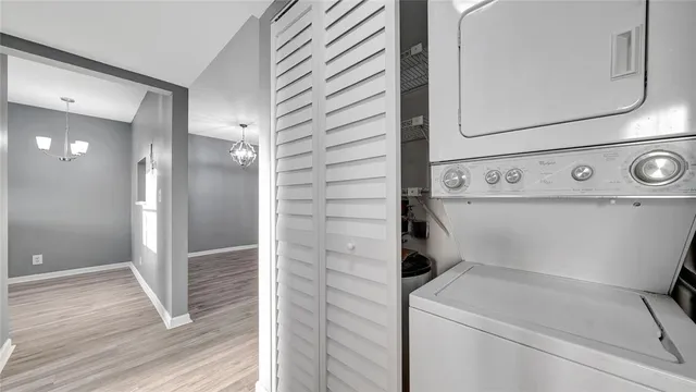 a kitchen with a refrigerator a sink and dishwasher with wooden floor