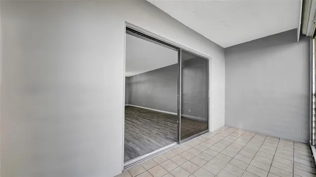 a view of a hallway and a livingroom with wooden floor