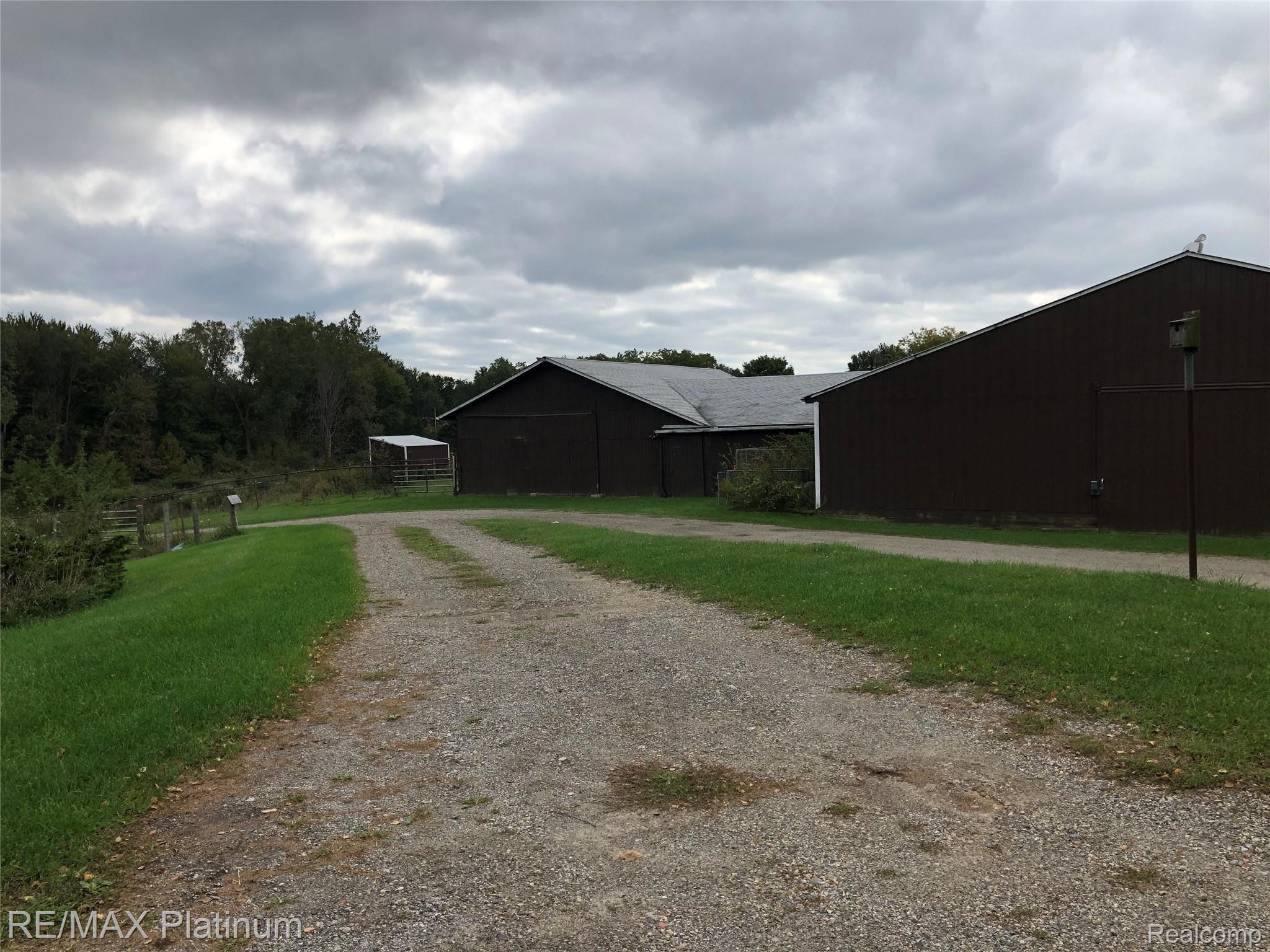 7933 North Fleming Road Fowlerville, MI 48836 - Photo 30 of 35 Barn with Horse Stalls and Arena