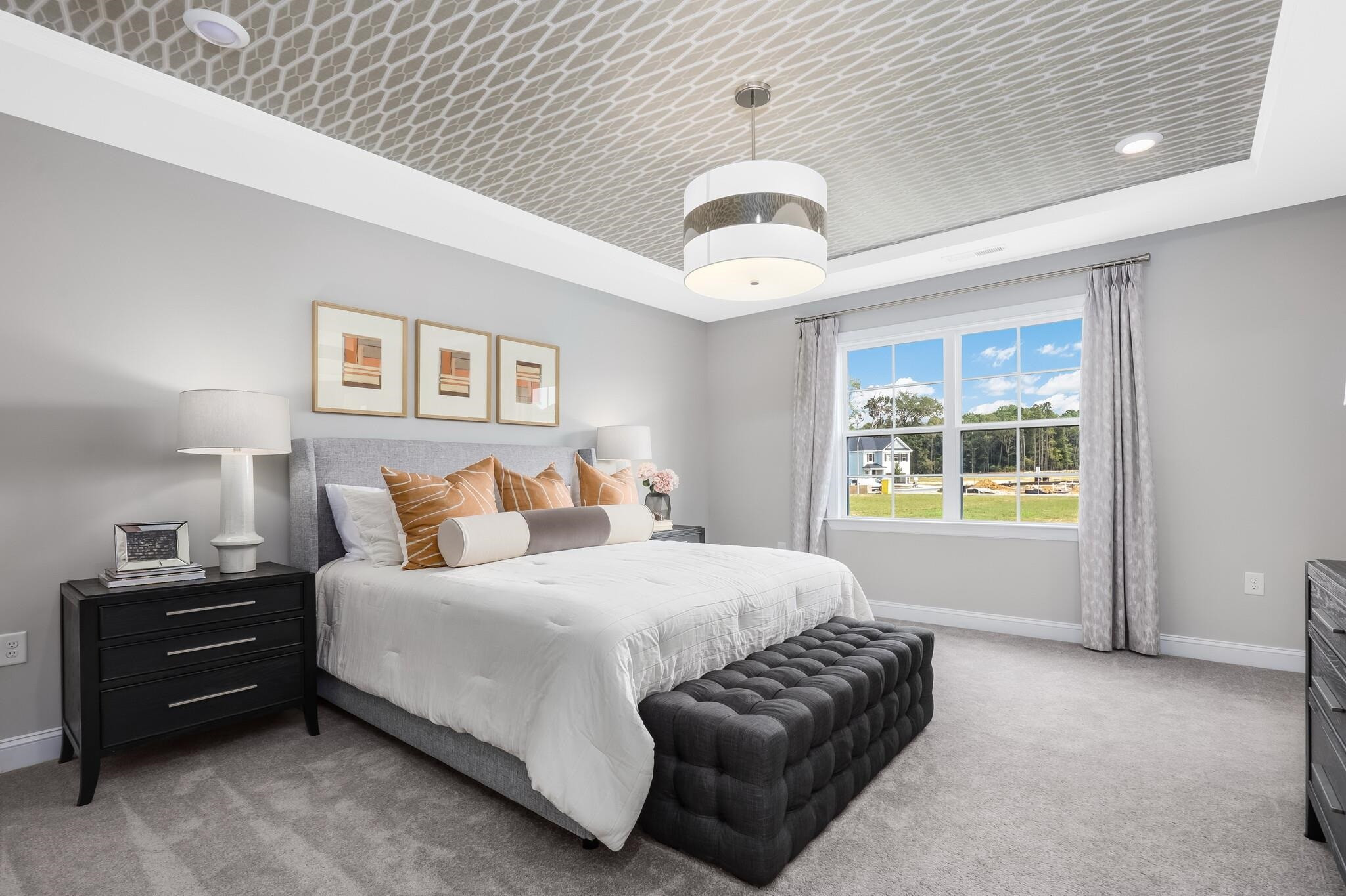 116 Canyon Gap Way, Unit 177 Raleigh, NC 27610 - Photo 25 of 38 a spacious bedroom with a bed and a chandelier