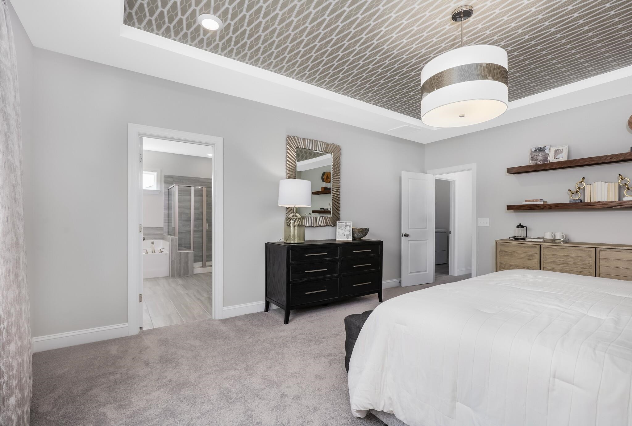 116 Canyon Gap Way, Unit 177 Raleigh, NC 27610 - Photo 26 of 38 a bedroom with a bed and a chandelier