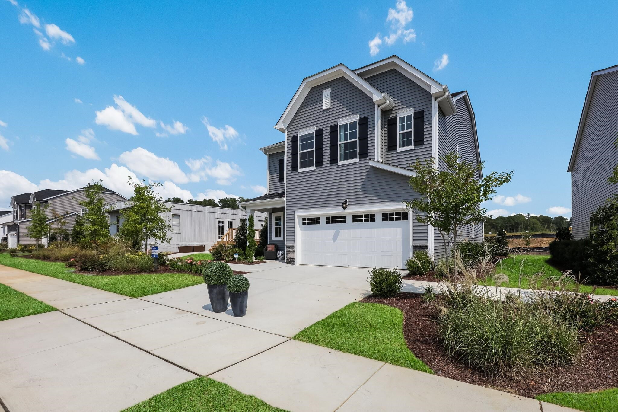 116 Canyon Gap Way, Unit 177 Raleigh, NC 27610 - Photo 4 of 38 a front view of a house with a garden
