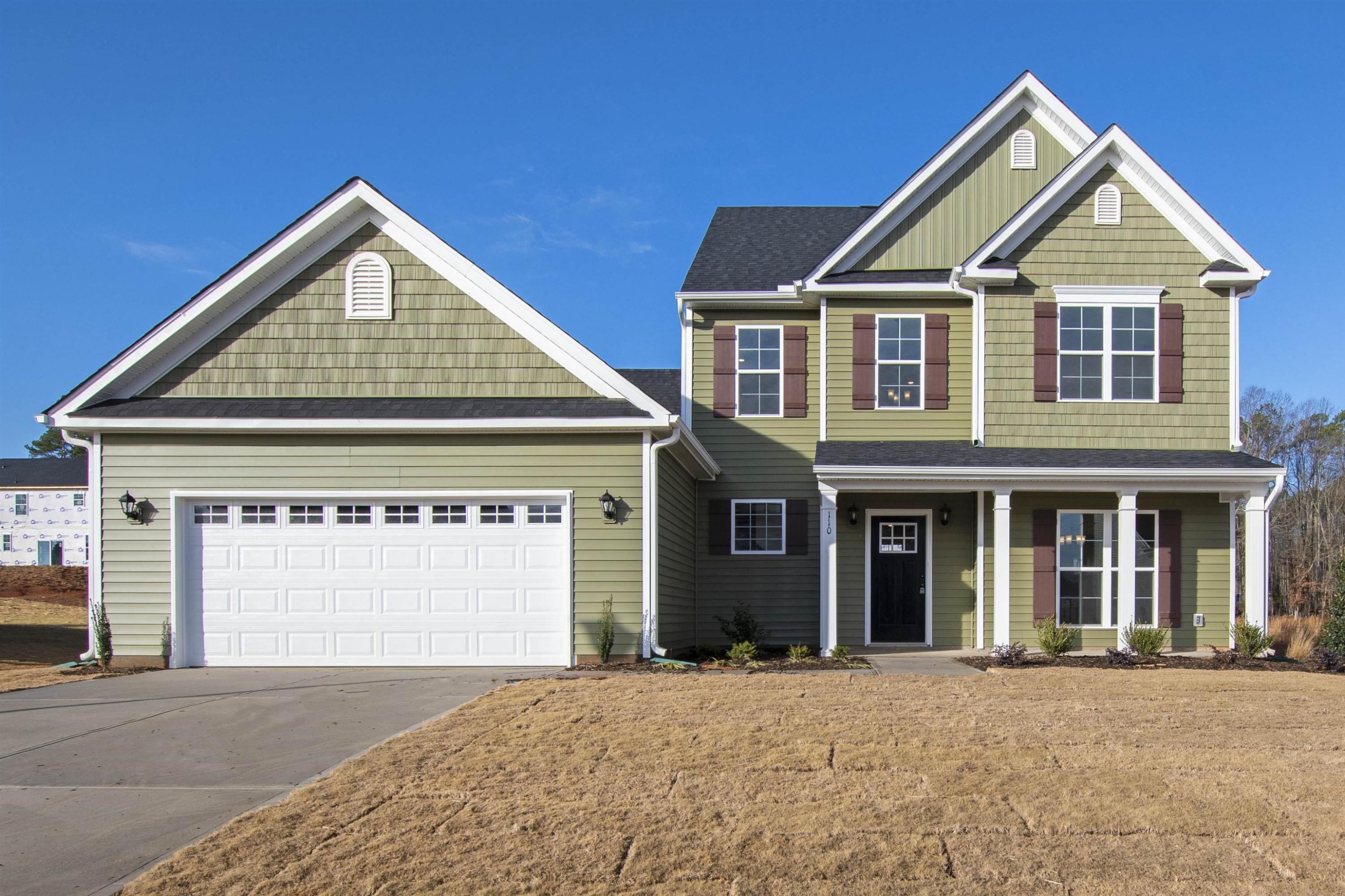45 Cutshaw Road Youngsville, NC 27596 - Photo 1 of 49 a front view of a house with a yard and garage