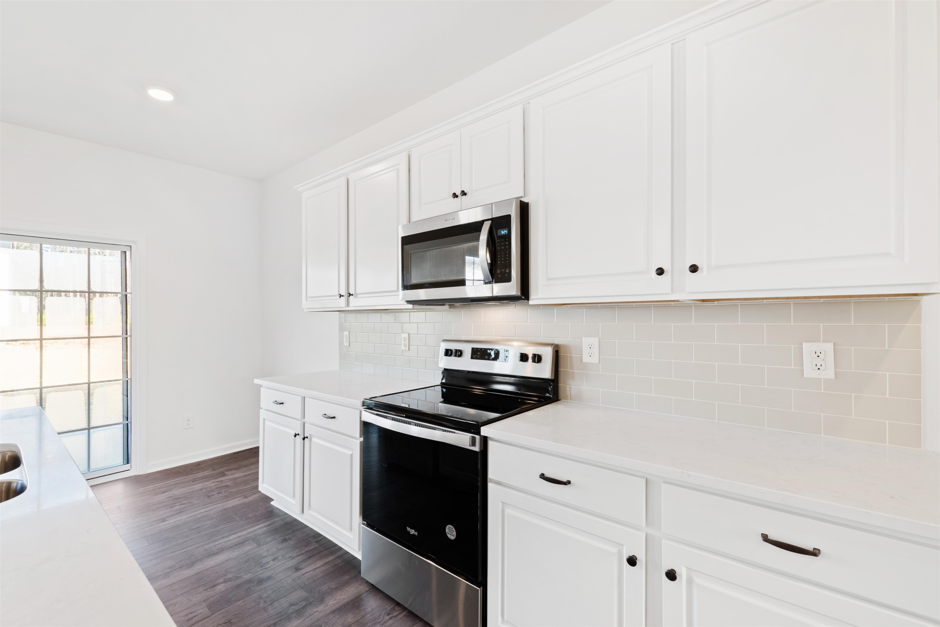 45 Cutshaw Road Youngsville, NC 27596 - Photo 13 of 49 a kitchen with white cabinets and black appliances