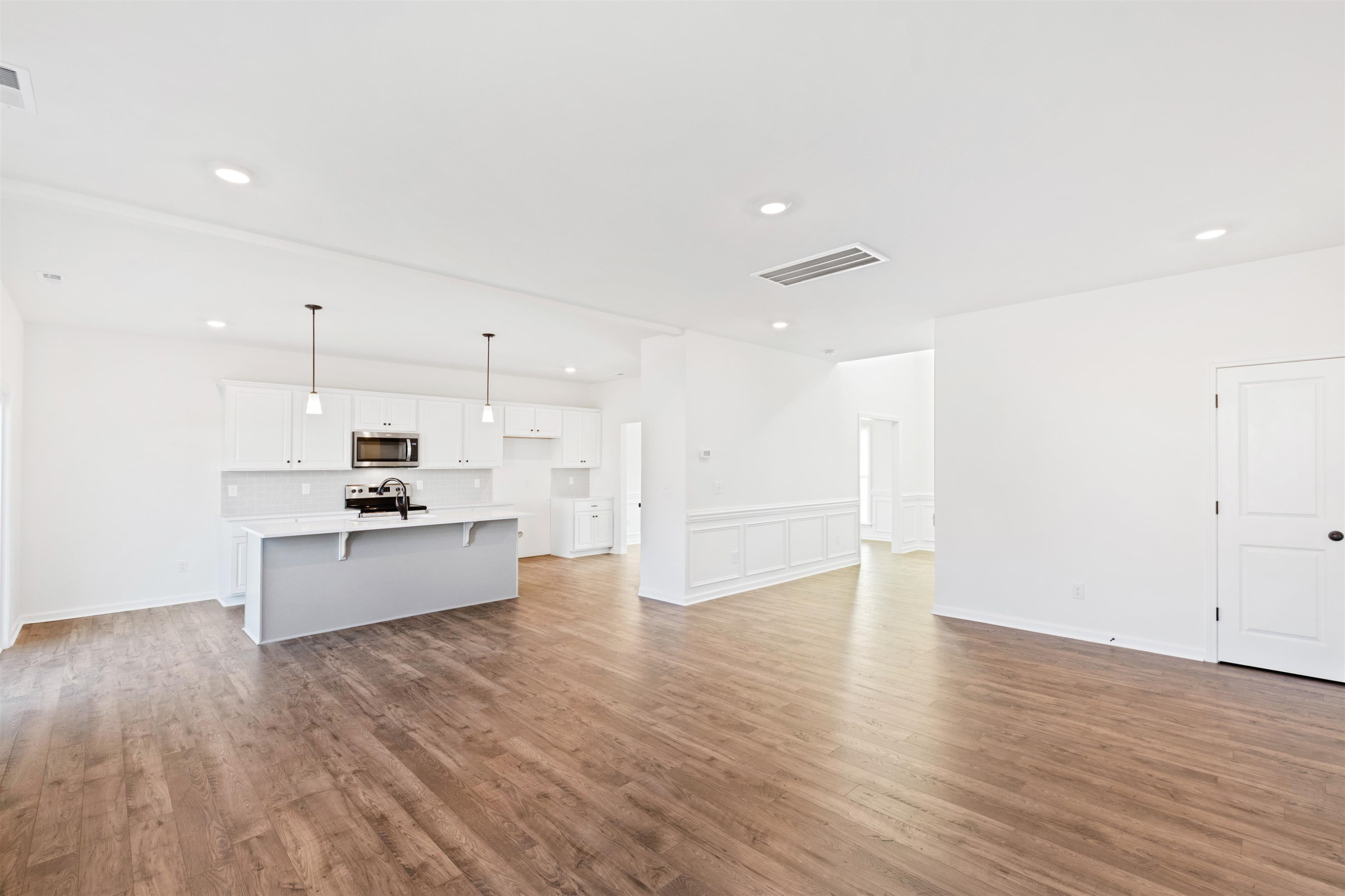45 Cutshaw Road Youngsville, NC 27596 - Photo 2 of 49 a kitchen with stainless steel appliances kitchen island wooden floors and white cabinets