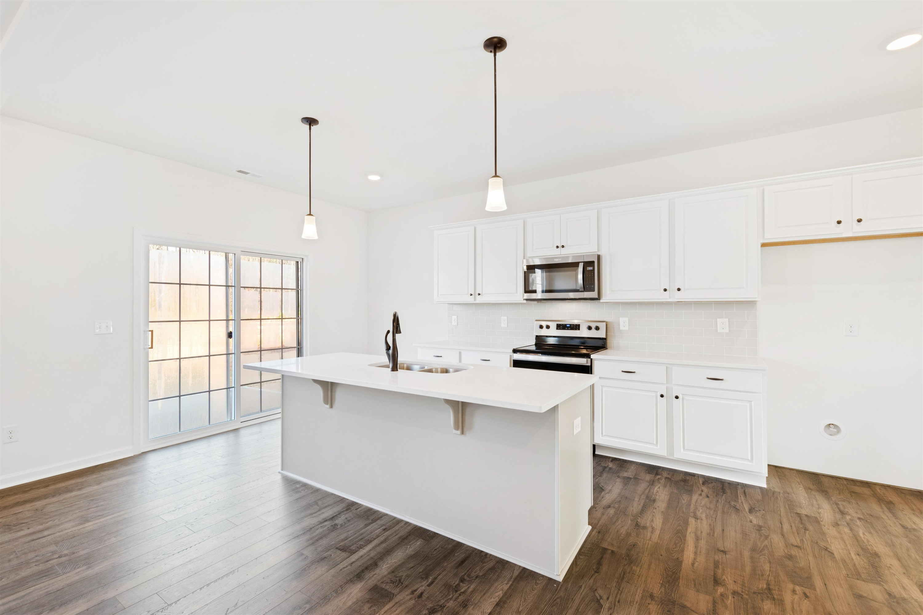 45 Cutshaw Road Youngsville, NC 27596 - Photo 3 of 49 a kitchen with stainless steel appliances granite countertop a stove a sink a center island and a window
