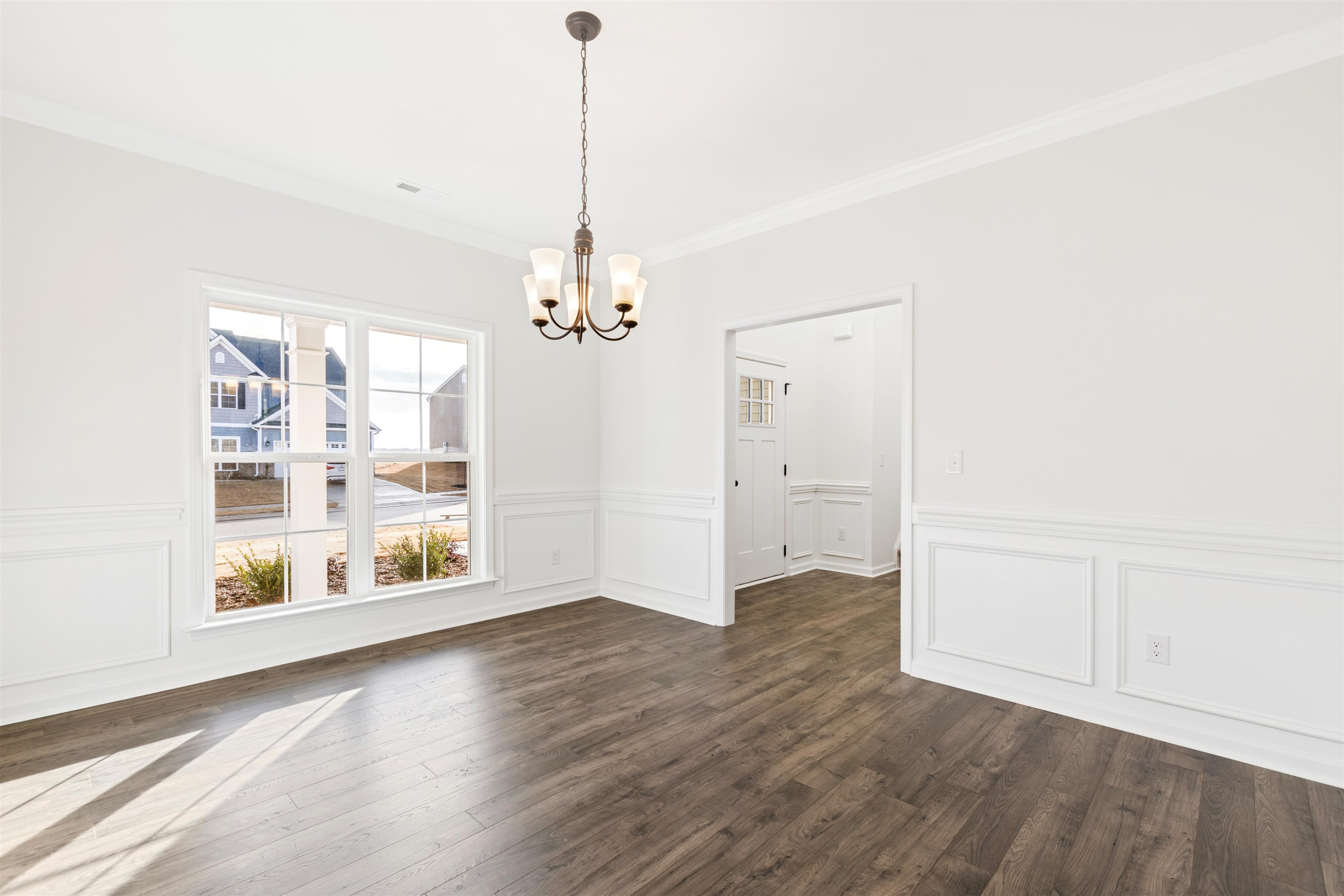 45 Cutshaw Road Youngsville, NC 27596 - Photo 4 of 49 a view of an empty room with a window and wooden floor