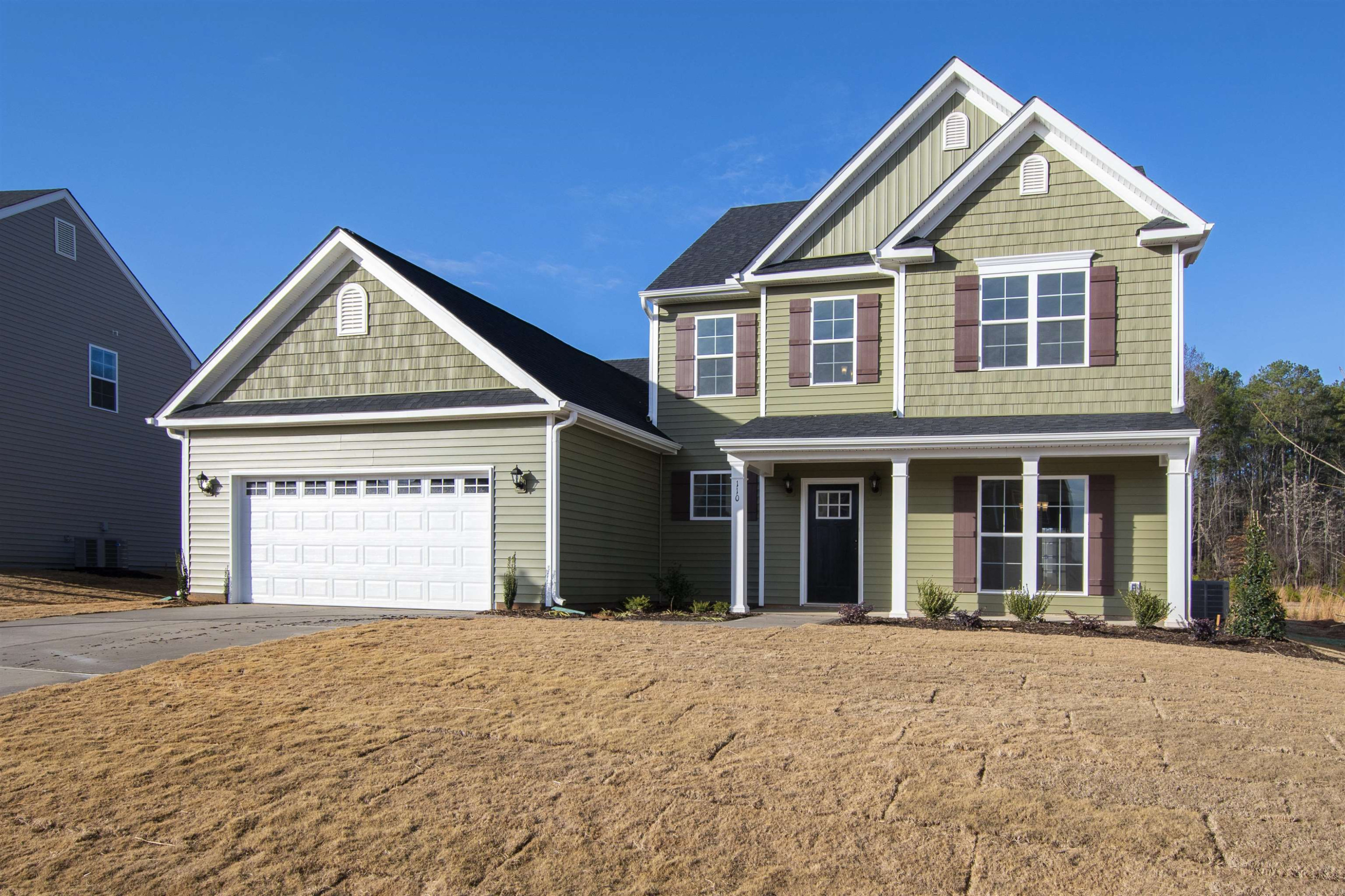 45 Cutshaw Road Youngsville, NC 27596 - Photo 45 of 49 a front view of a house with a yard and garage