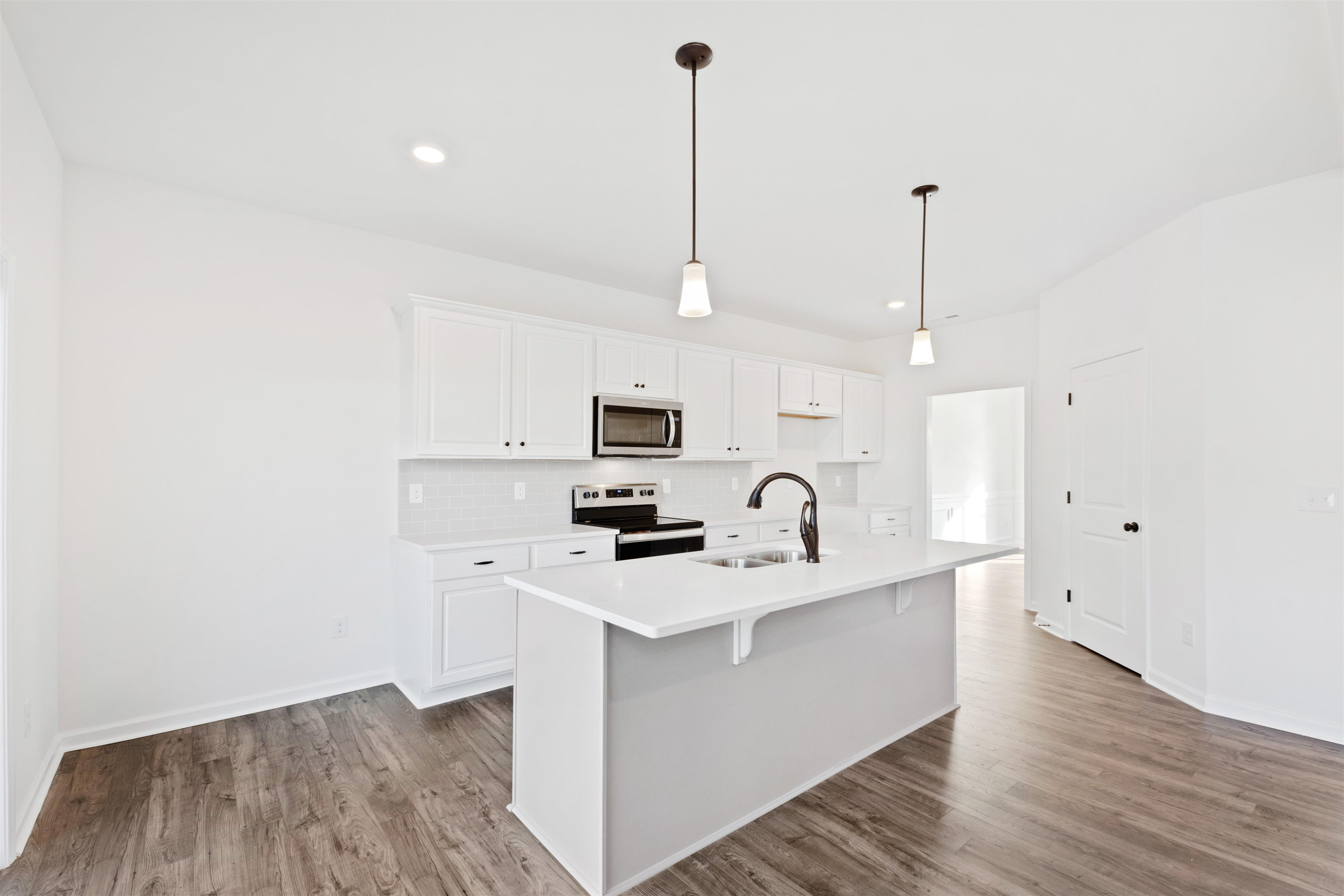 45 Cutshaw Road Youngsville, NC 27596 - Photo 9 of 49 a kitchen with stainless steel appliances kitchen island a sink and a wooden floor