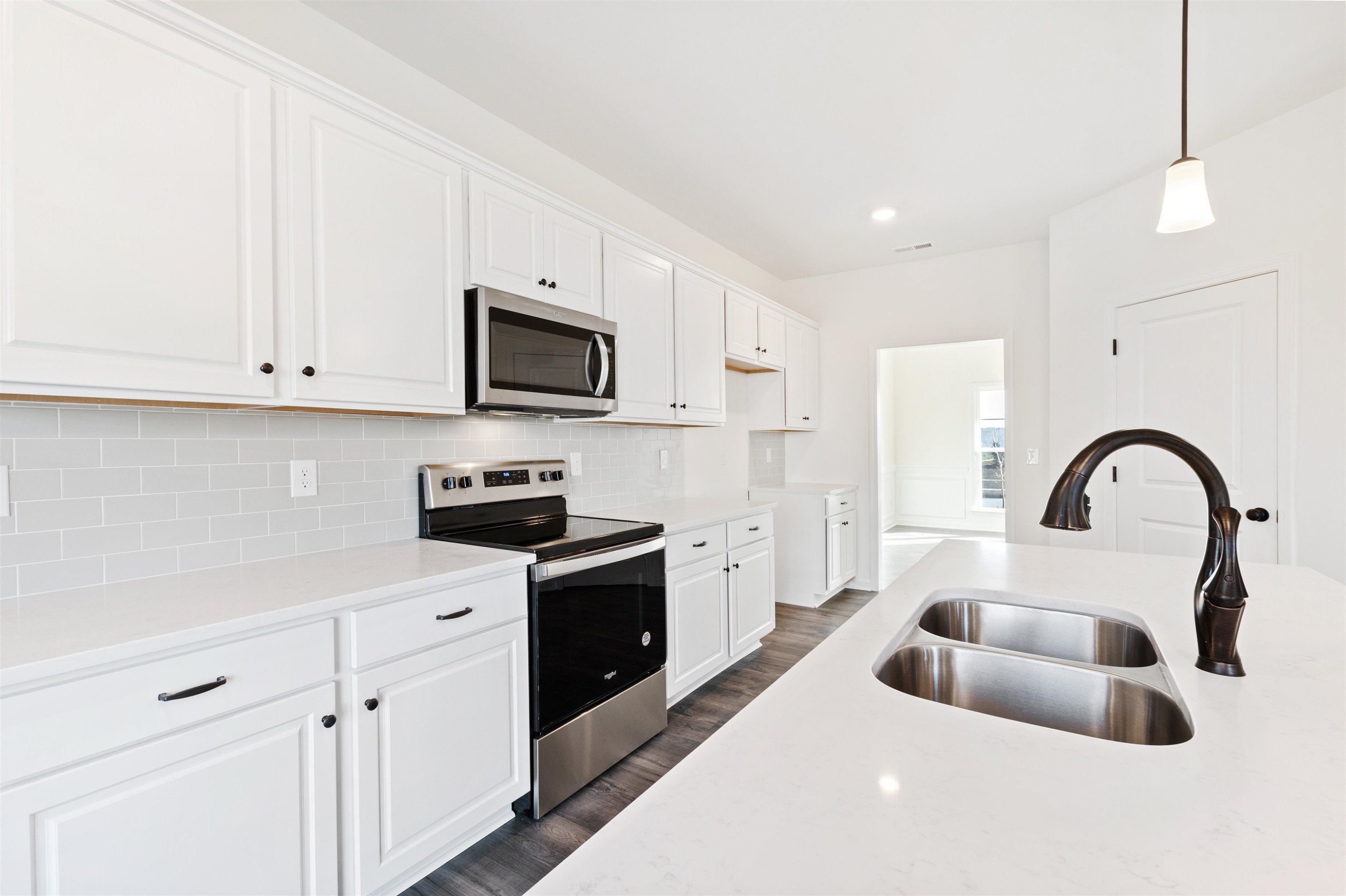 45 Cutshaw Road Youngsville, NC 27596 - Photo 10 of 49 a kitchen with stainless steel appliances granite countertop a sink a stove and a refrigerator with wooden floor