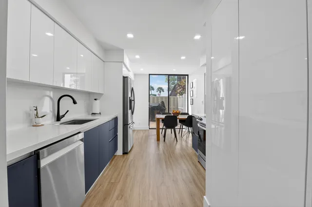 a dining room with furniture and a floor to ceiling window