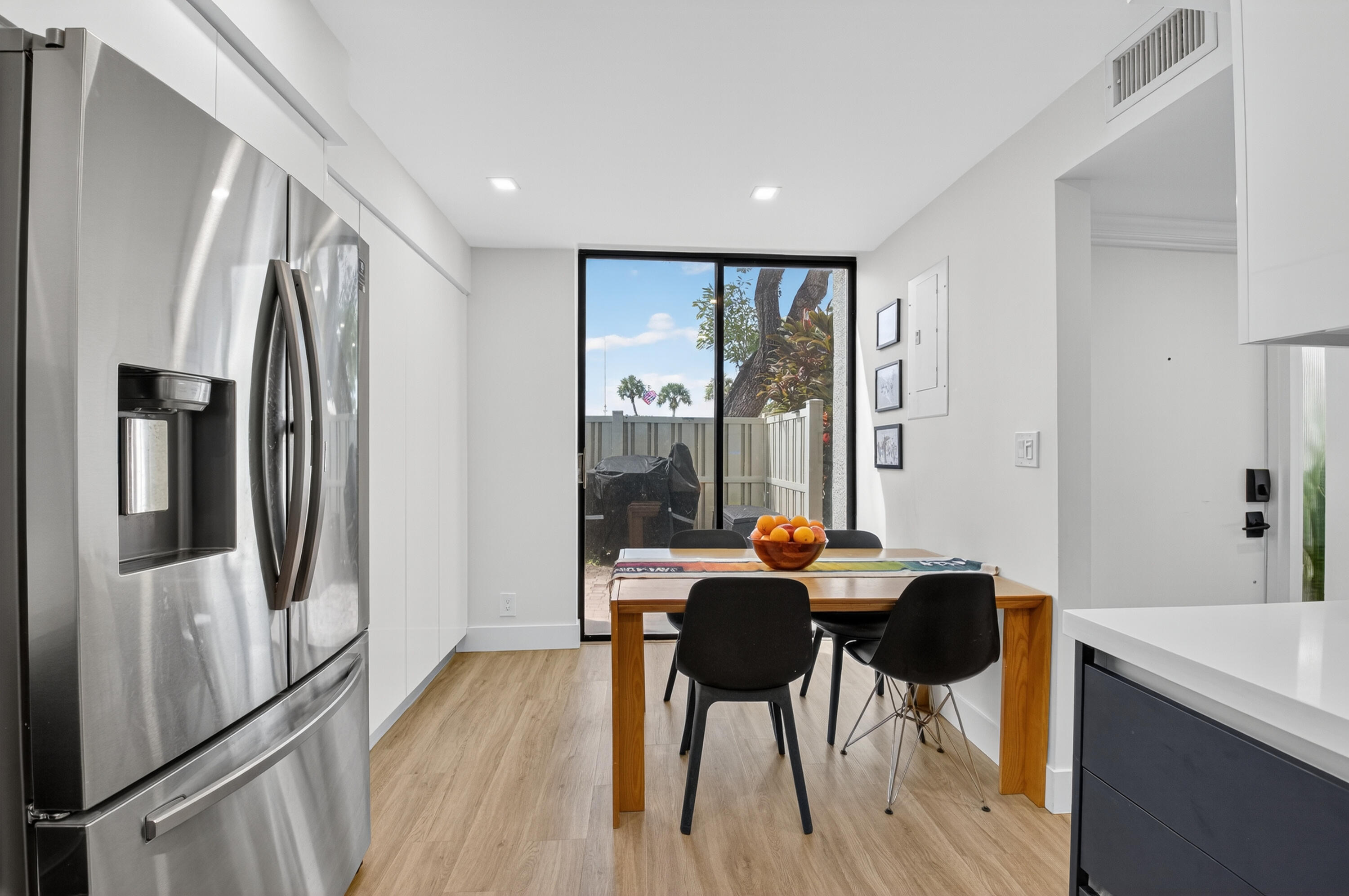 701 Bridgewood Drive Boca Raton, FL 33434 - Photo 16 of 81 a dining room with furniture and a floor to ceiling window