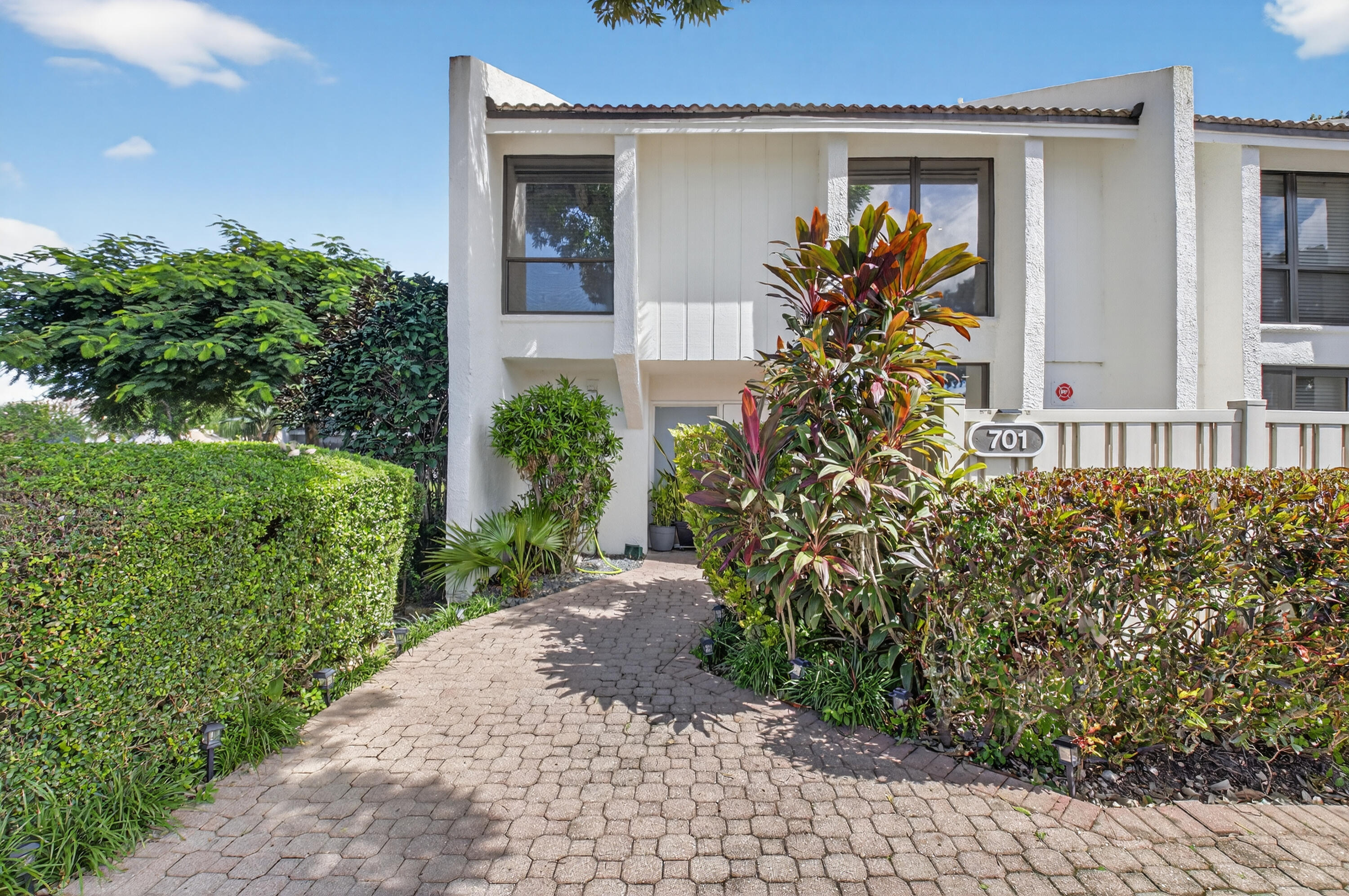701 Bridgewood Drive Boca Raton, FL 33434 - Photo 2 of 81 a front view of a house with a yard