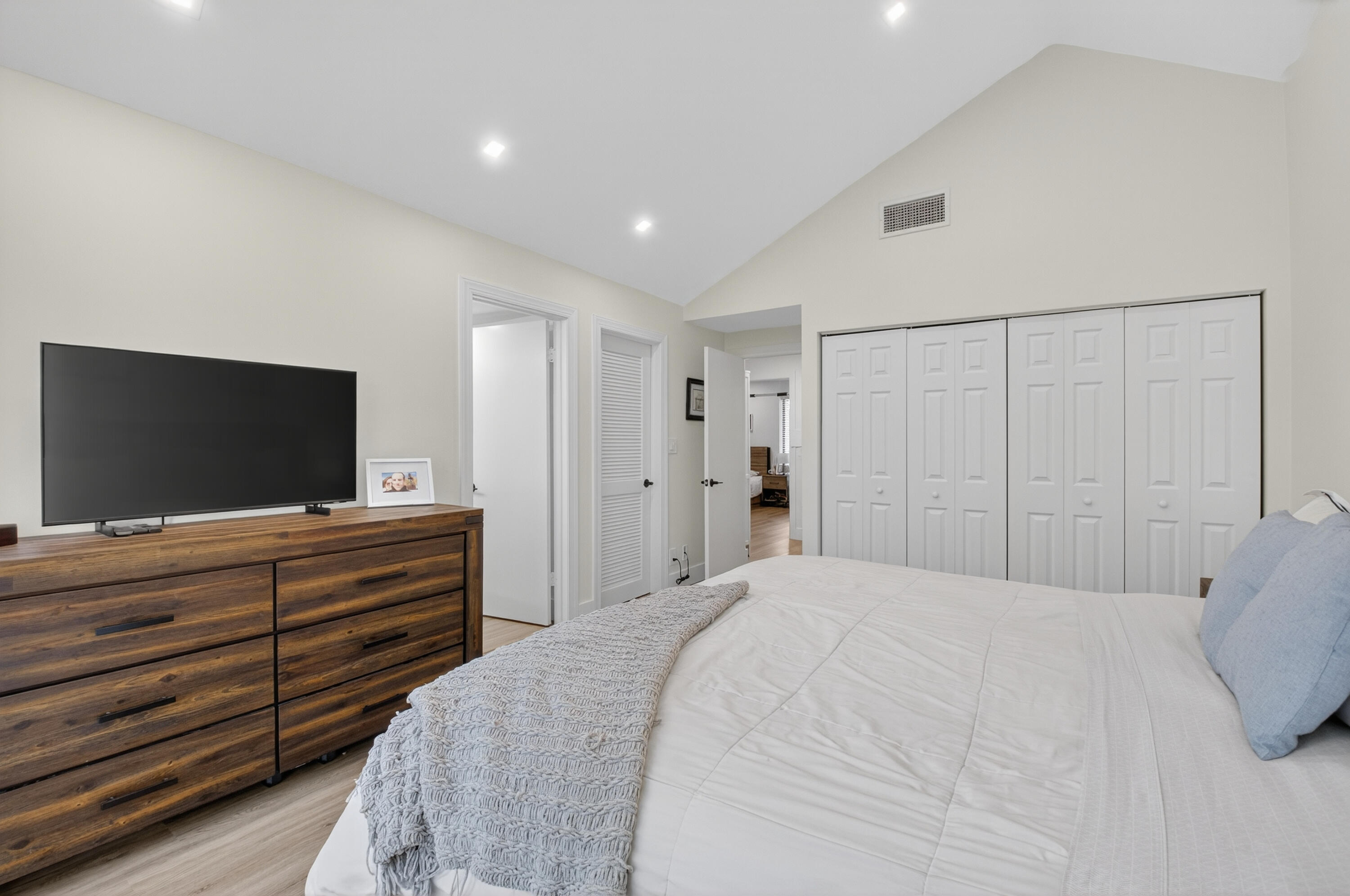 701 Bridgewood Drive Boca Raton, FL 33434 - Photo 28 of 81 a bedroom with a bed and a flat screen tv in it