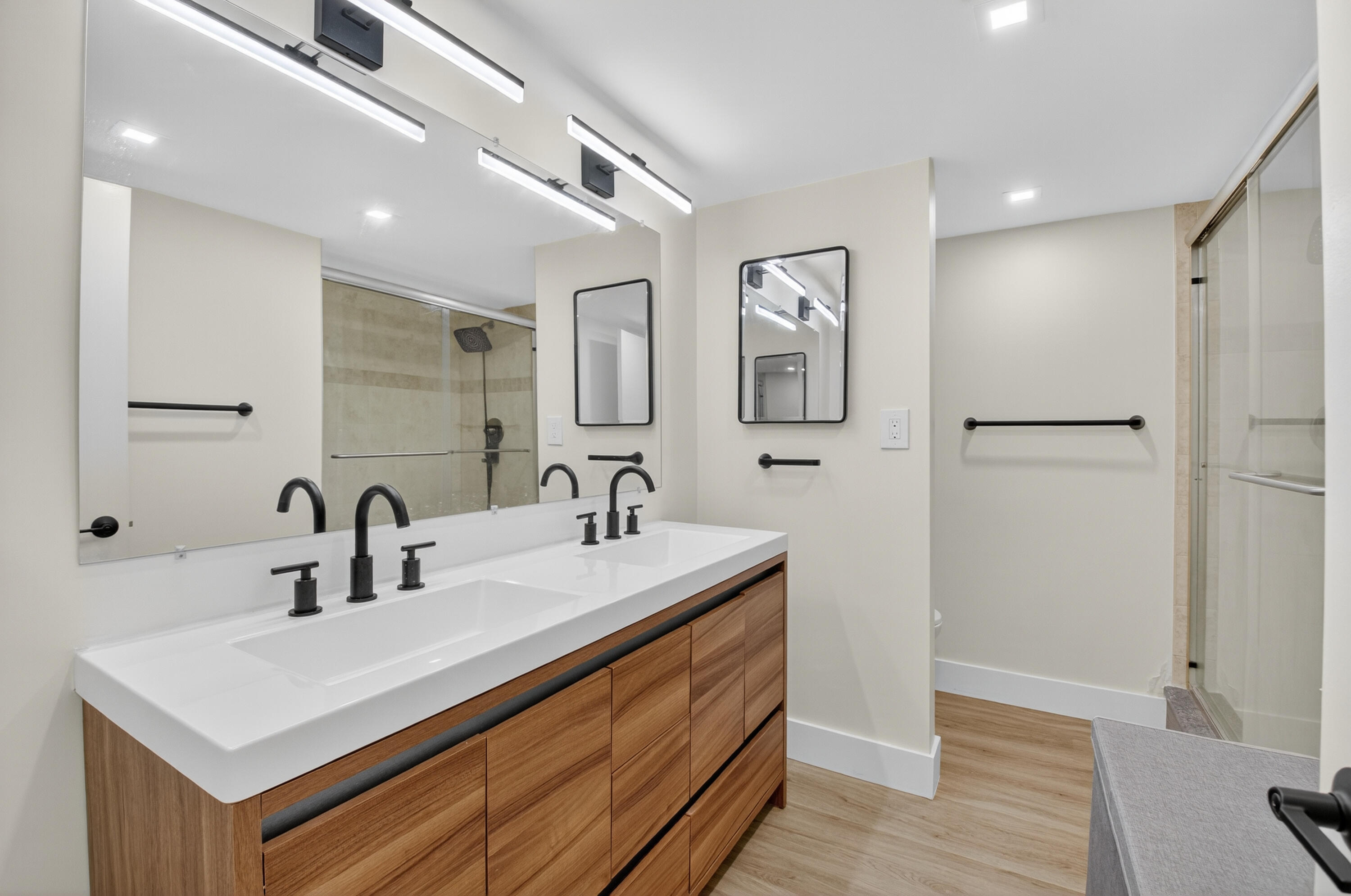 701 Bridgewood Drive Boca Raton, FL 33434 - Photo 30 of 81 a bathroom with a sink a mirror and a toilet