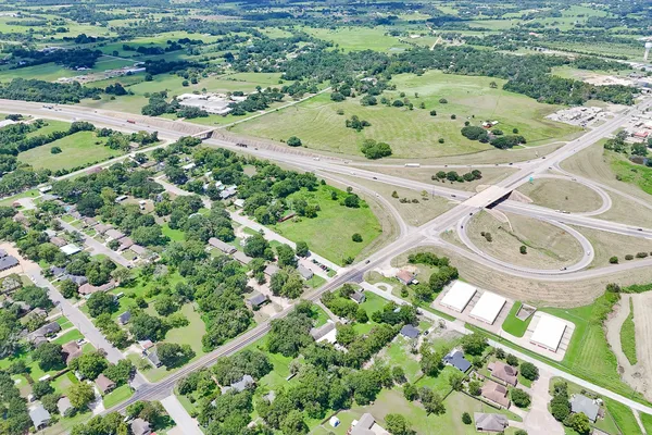 an aerial view of a house with a yard and lake view in back